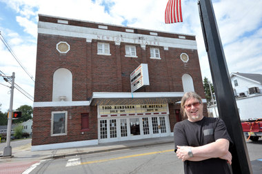Owner Jonathan Peirce stands in front of The Newton Theatre.